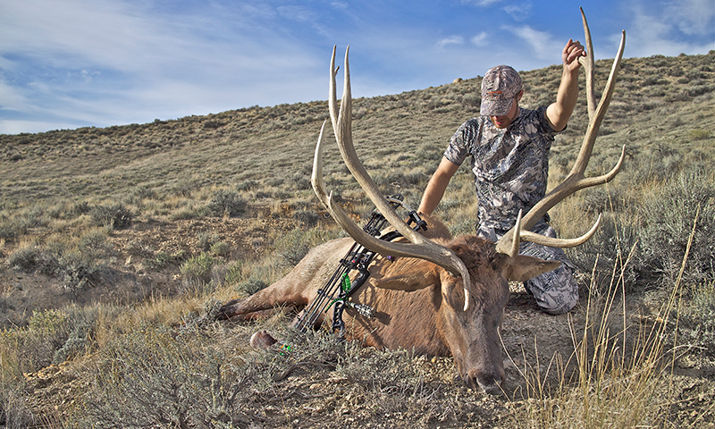 Hunter posing with an elk